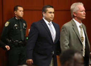 George Zimmerman is escorted into the courtroom by armed Sheriffs.